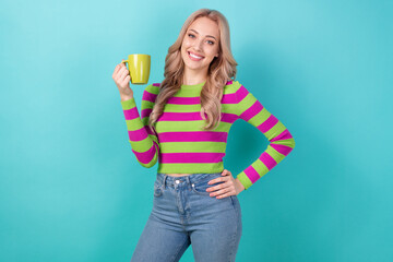 Photo of pretty cute woman dressed striped sweater drinking hot herbal tea isolated turquoise color background
