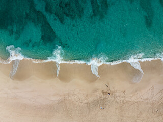 Aerial of sandy beach with ocean