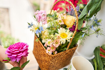 Master class on making bouquets. Spring bouquet in wicker basket. Learning flower arranging, making beautiful bouquets with your own hands