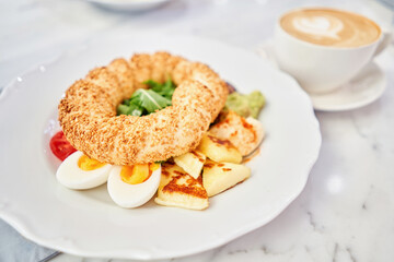 Turkish breakfast with simit, cheese, tomato, cucumber, olives. Breakfast with coffee in the restaurant. Morning nutritious meal