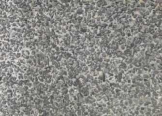 Dark gray exposed aggregate concrete for walls or floors. Background and texture.