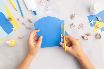 Paper bucket of shells summer idea for kids craft in kindergarten hands ocean's day © Angelina Zinovieva