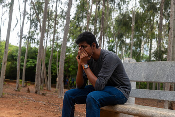 Depressed Indian Man Sitting in Park