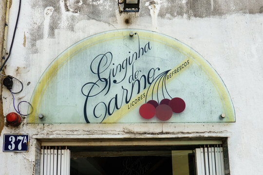 LISBON, PORTUGAL - JUNE 27, 2023: Ginginha do Carmo in Lisbon, Portugal. Famous small bar at the stairs of Cal&ccedil;ada do Carmo serving Ginjinha, a Portuguese cherry liqueur.
