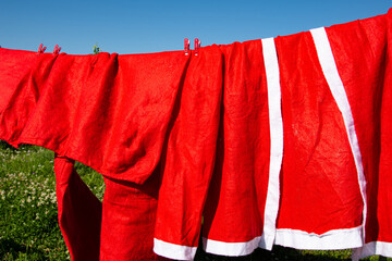 The Santa Claus costume dries on a rope.