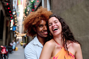 happy tourists couple in Barcelona looking at camera and laughing