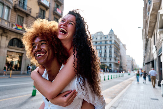 couple of tourists doing piggyback in Barcelona, Spain