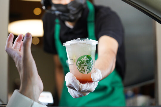 Starbucks workers give orders at the drive-thru. Lemonade strawberry. 
