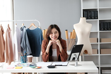 Asian female clothing designer working inside office.