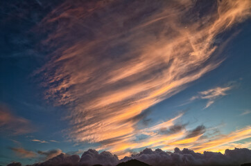 Fototapeta premium Pink Cirrus Clouds in the Mountains at Sunrise or Sunset.