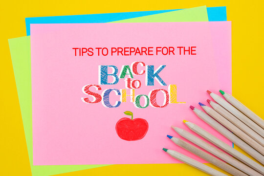 Tips to prepare for Back to School. Top view flat lay concept. Lettering, colored paper, multi-coloured letters, supplies for school