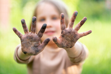 Little girl showing her dirty hands