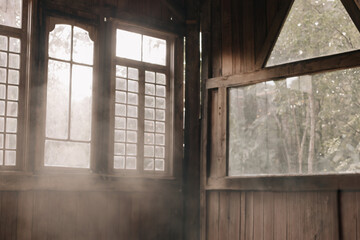 interior of a barn with plenty of natural light coming in. smokes in rays of sun.