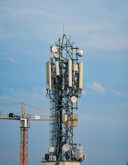 communication (cellular phone network) tower with antenna on rooftop of high rise building in suburban West Bengal.