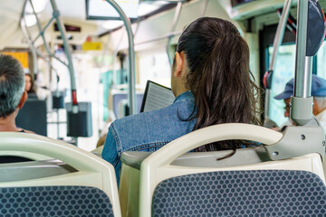 Woman reading ebook on bus seat. Comfortable mode of transportation for public travel.