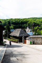Old museum house from 1918 and the new wall monastery in the background. Izbuc monastery.  Bihor, Romania.