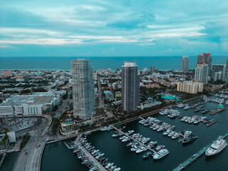 Fototapeta na wymiar Miami Beach skyline, Florida. Miami Beach city skyline view from aerial drone. Skyscrapers and harbor. Miami Beach waterfront lined with marinas. Miami beach top view from South Point Park.