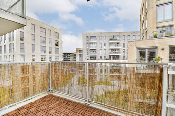 an outdoor area with wood flooring and wooden fenced in the middle part of the building, surrounded by trees
