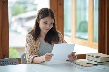 Asian woman receive good news reading letter apply to university admission concept.