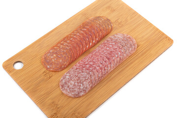 Sliced chorizo and cervelat sausages on a cutting board over white background.