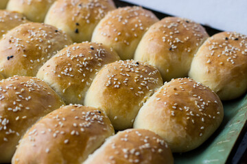 Homemade pies sprinkled with sesame seeds. Appetizing homemade cakes