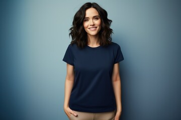 Portrait of a beautiful fictional woman smiling. Brunette model wearing a navy blue t-shirt, isolated on a plain colored background. Generative AI illustration. - obrazy, fototapety, plakaty