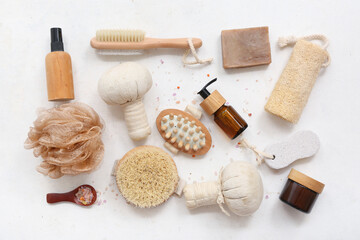 Composition with different bath accessories and cosmetics on light background