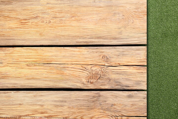 Wooden table against green grass background, closeup
