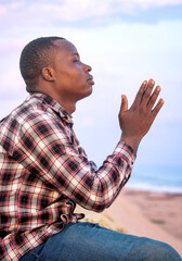 A powerful image of a Christian person deeply in prayer, their profile against the backdrop of an...