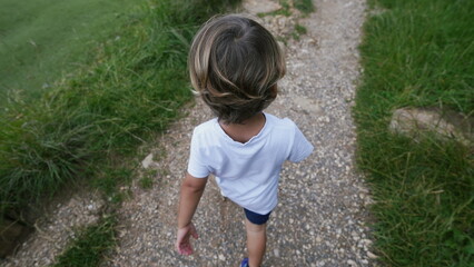 One small boy walking on path from above angle of kid