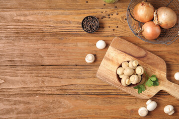Bowl with canned mushrooms and ingredients for preservation on wooden background