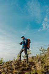 Fototapeta na wymiar Exploring Nature's Wonders: Hiker Traveler Immersed in Photography