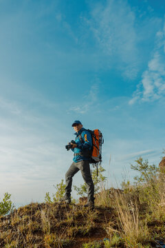 Exploring Nature's Wonders: Hiker Traveler Immersed in Photography