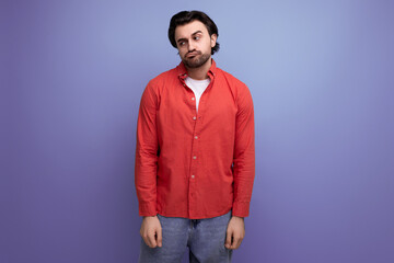 well-groomed caucasian brunette 30s man in a red shirt thought
