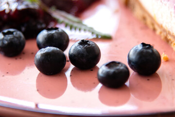 Serveral freash blueberry on pink plate