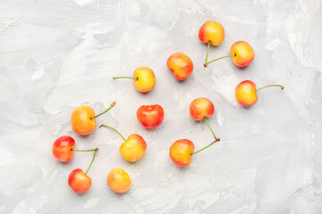 Naklejka na ściany i meble Many sweet yellow cherries on grunge background