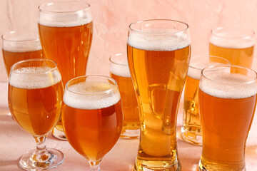 Glasses of cold beer on beige background. Oktoberfest celebration