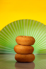 A stack of plain cake donuts, art nouveau style background