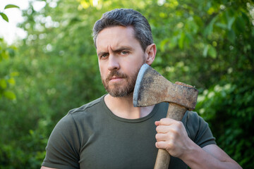 masculine guy man with axe. bearded masculine guy with axe. masculine guy with axe outdoor.