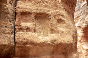View of a wall with a man-made sandstone window. Petra, Jordan