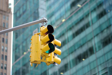 Yellow Traffic Light on background of skyscrapers, Manhattan, New York, USA. Red stop signal.
