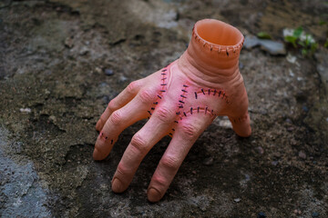 Scary realistic human hand with scars and stiches. Cut off hand with active fingers. Plastic toy.