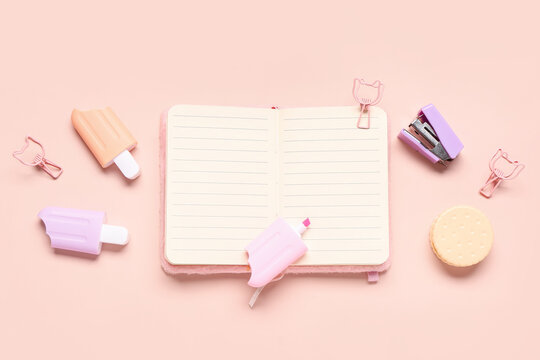 Stylish blank notebook and different stationery on pink background