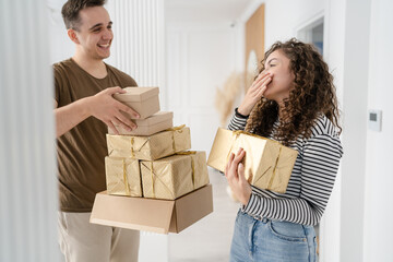 man and woman give gift box presents at home holiday surprise concept - obrazy, fototapety, plakaty