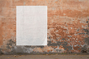blank advertising poster glued to the weathered wall - copy space in pasted billboard on peeling plaster - 623241178
