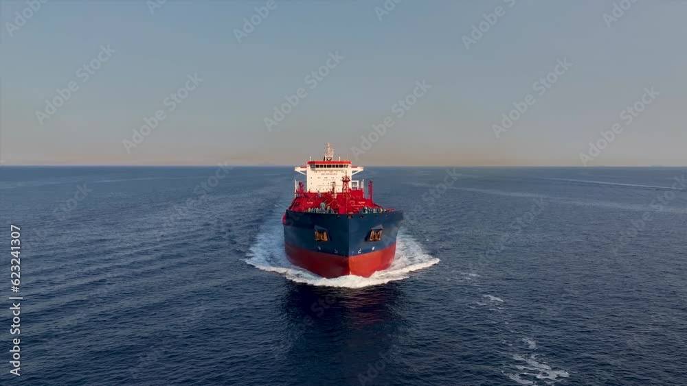 Canvas Prints Front view of a large crude oil or chemical goods tanker ship traveling over the ocean during sunset time