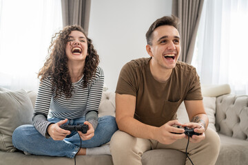 caucasian couple spend time together play console video games at home