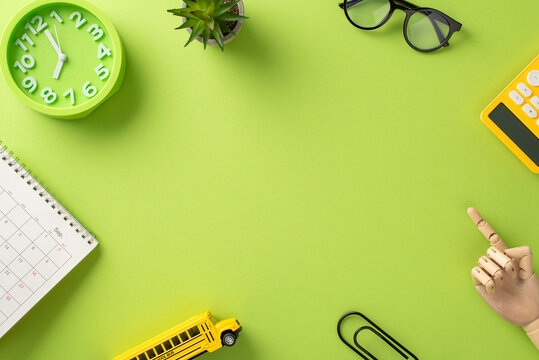 Immerse yourself in the world of education with this top-view photo showcasing organized child's workplace on an isolated light green background, with round frame for text or advertisements