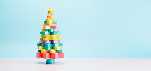 Minimal creative composition with a Christmas tree made of colorful children's blocks on a minimal pastel background. Holidays are a time for children's play. Generative AI.