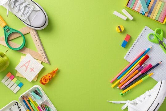 Showcase the essence of education with this top view picture of a pair of sneakers and various school supplies on a light green background. Perfect for educational advertisements and copy placement